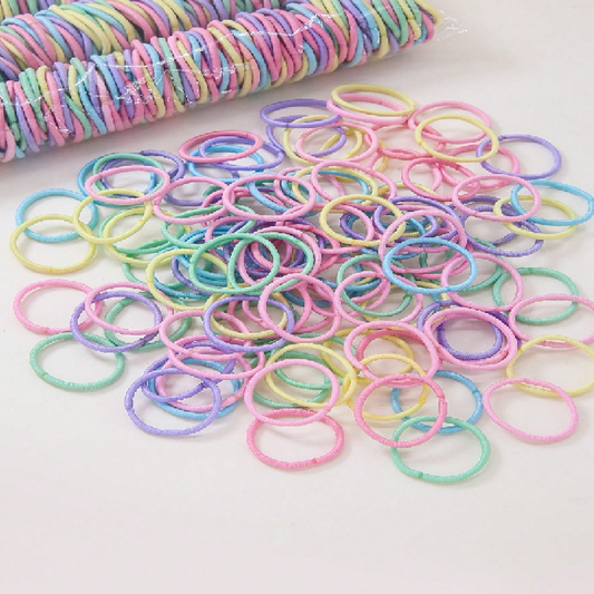 Pastel-colored rubber bands on a white background