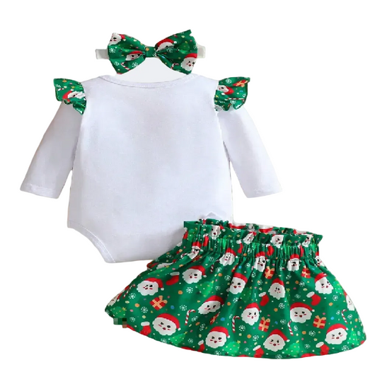 Christmas-themed baby outfit with white top, green skirt, and bow headbands on a wooden surface.