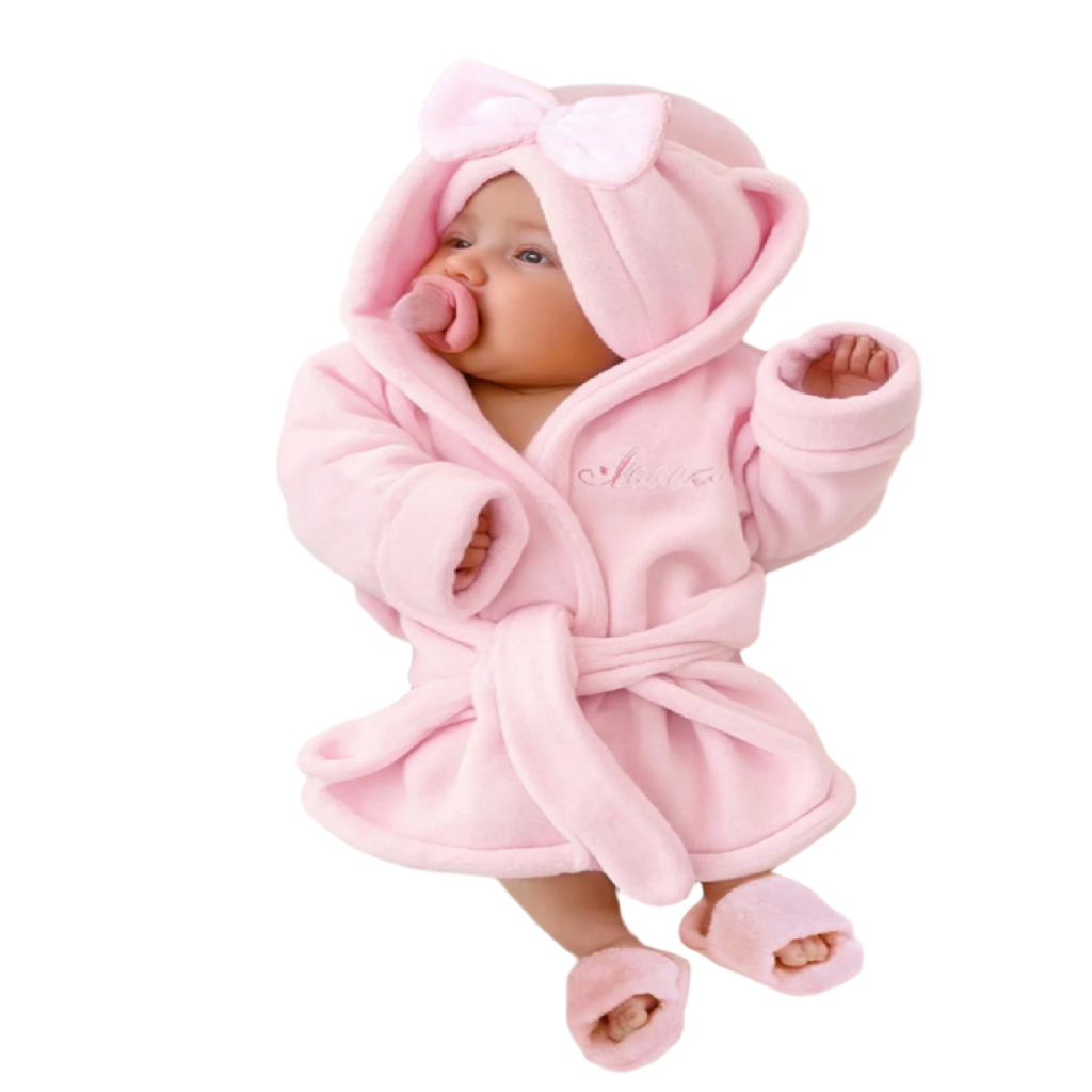 Baby wrapped in a pink robe with hat and slippers