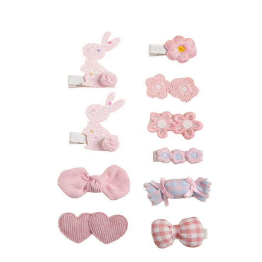 Set of pink hair accessories including clips and bands
