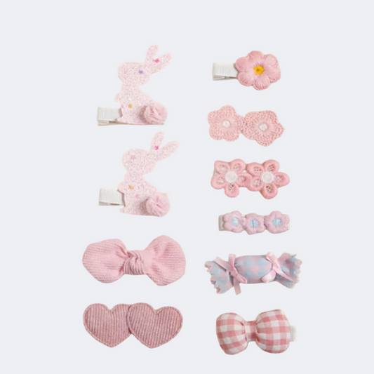 Set of pink hair accessories including clips and bands