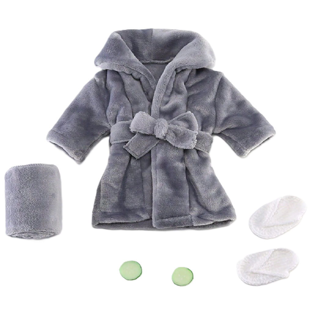 Gray plush robe with matching towel, washcloths, and bath bombs on a white background