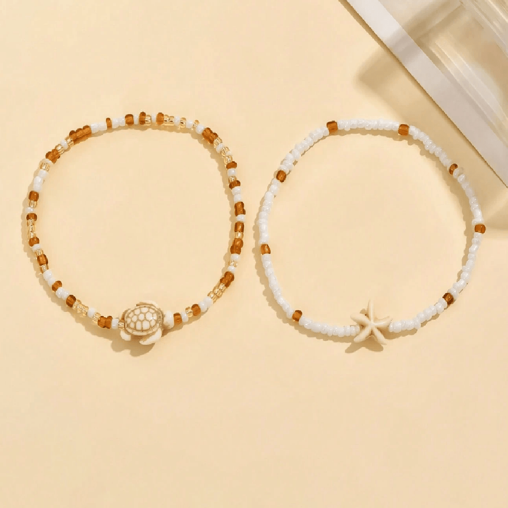 Two beaded bracelets with decorative elements on a beige background