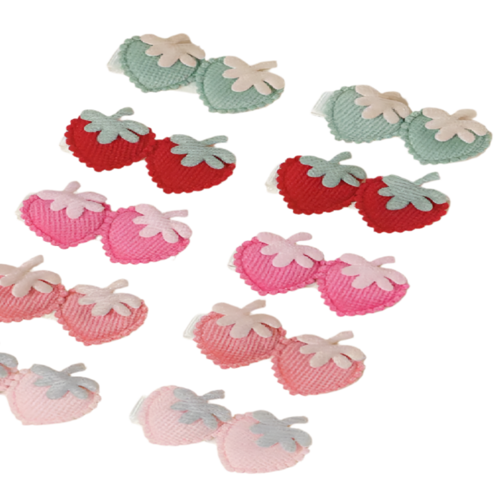 Decorative strawberry-shaped items in red, pink, and green on a beige background.