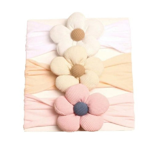 Floral headbands in pastel colors on a white background