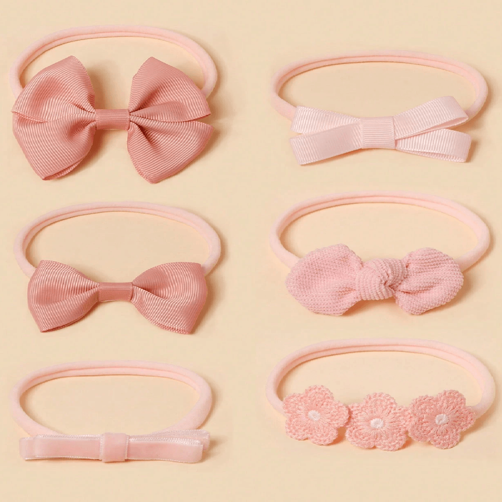 Set of pink hair accessories including bows and floral designs on a beige background