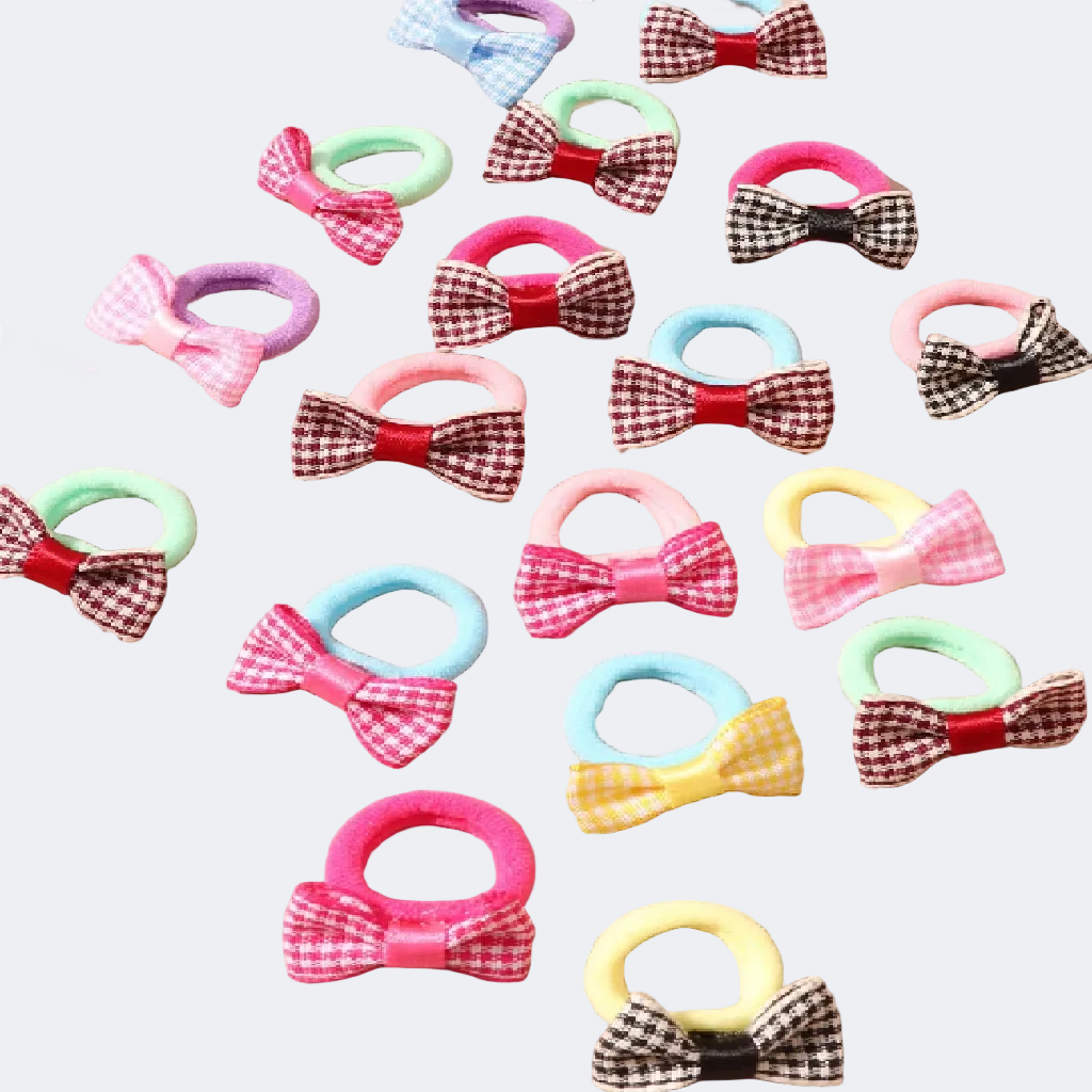 Collection of colorful hair ties with bows and checkered patterns on a beige background