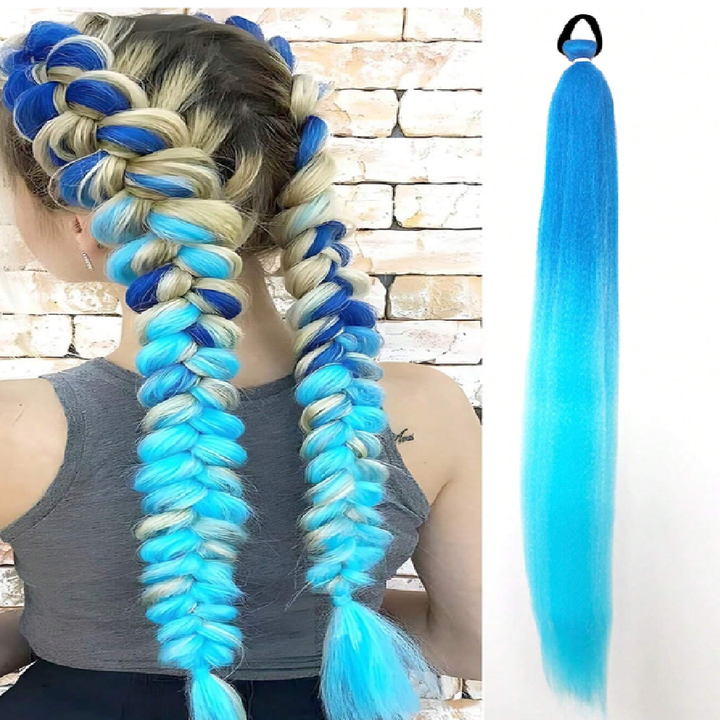 Blue and white braided hair extensions on a person with a stone wall background