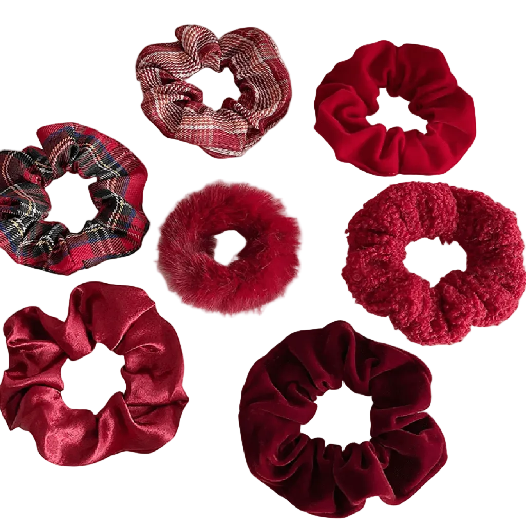 Collection of red and plaid scrunchies on a light gray background