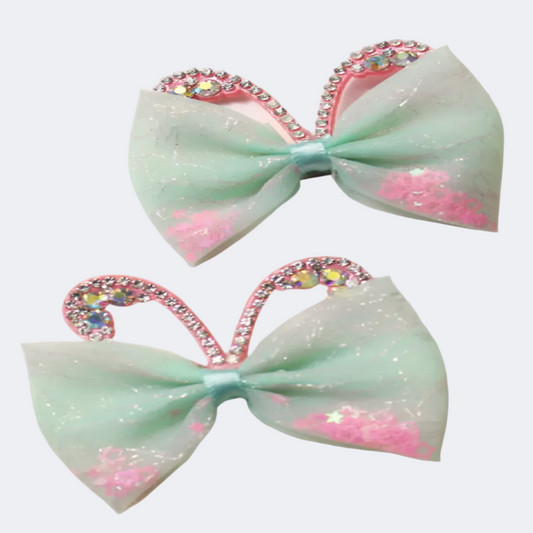 Two decorative bows with rhinestone hearts