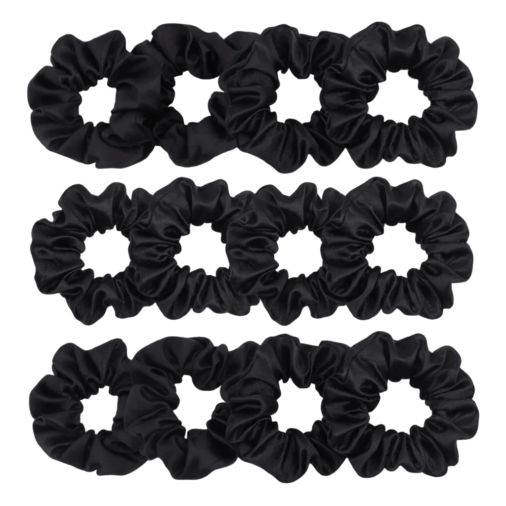 Set of black scrunchies on a light gray background