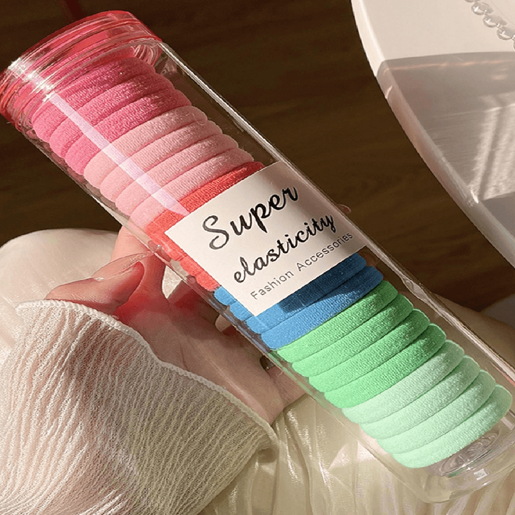 Packaged hair ties with a label indicating 'Super elasticity' held by a person.