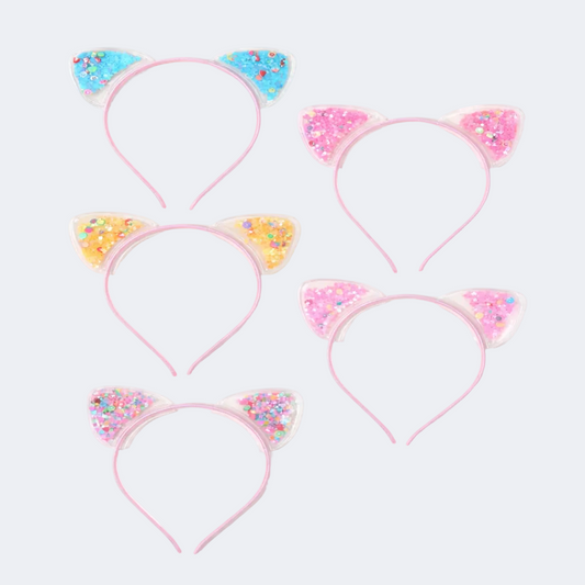 Set of four pink cat ear headbands with colorful decorations on a white background