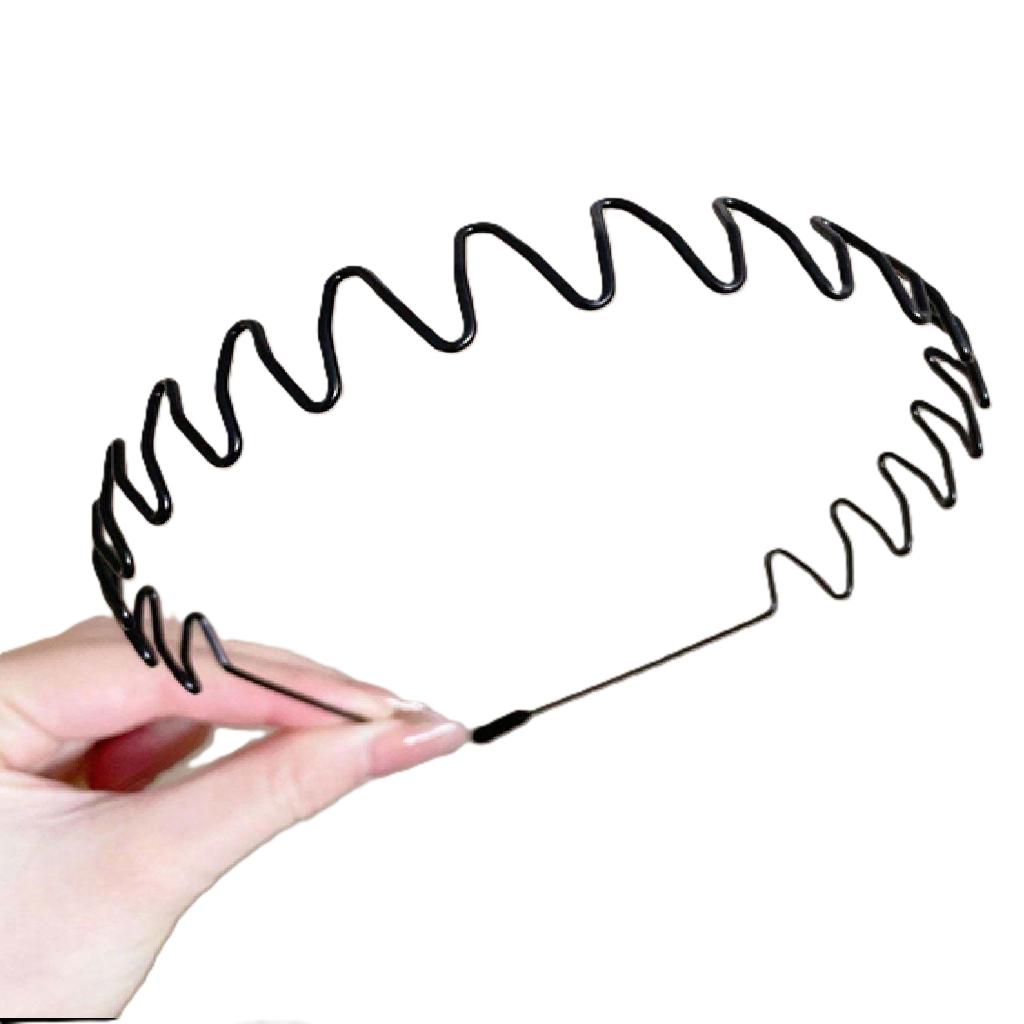 Black hairbrush with wavy bristle design held by a hand on a white background
