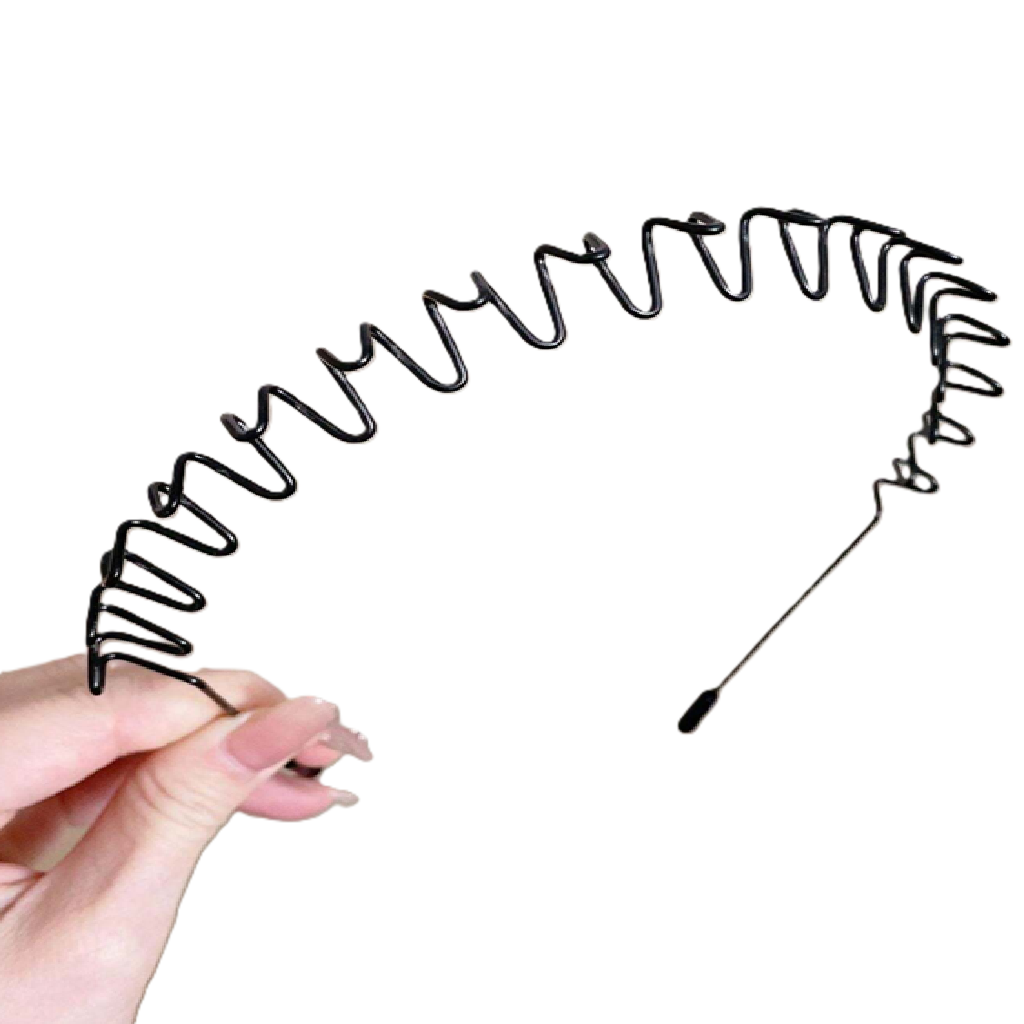 Coiled black spring held by a hand on a white background