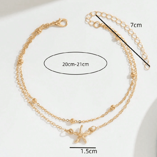 Gold anklets with starfish charms and measurement details on a white background