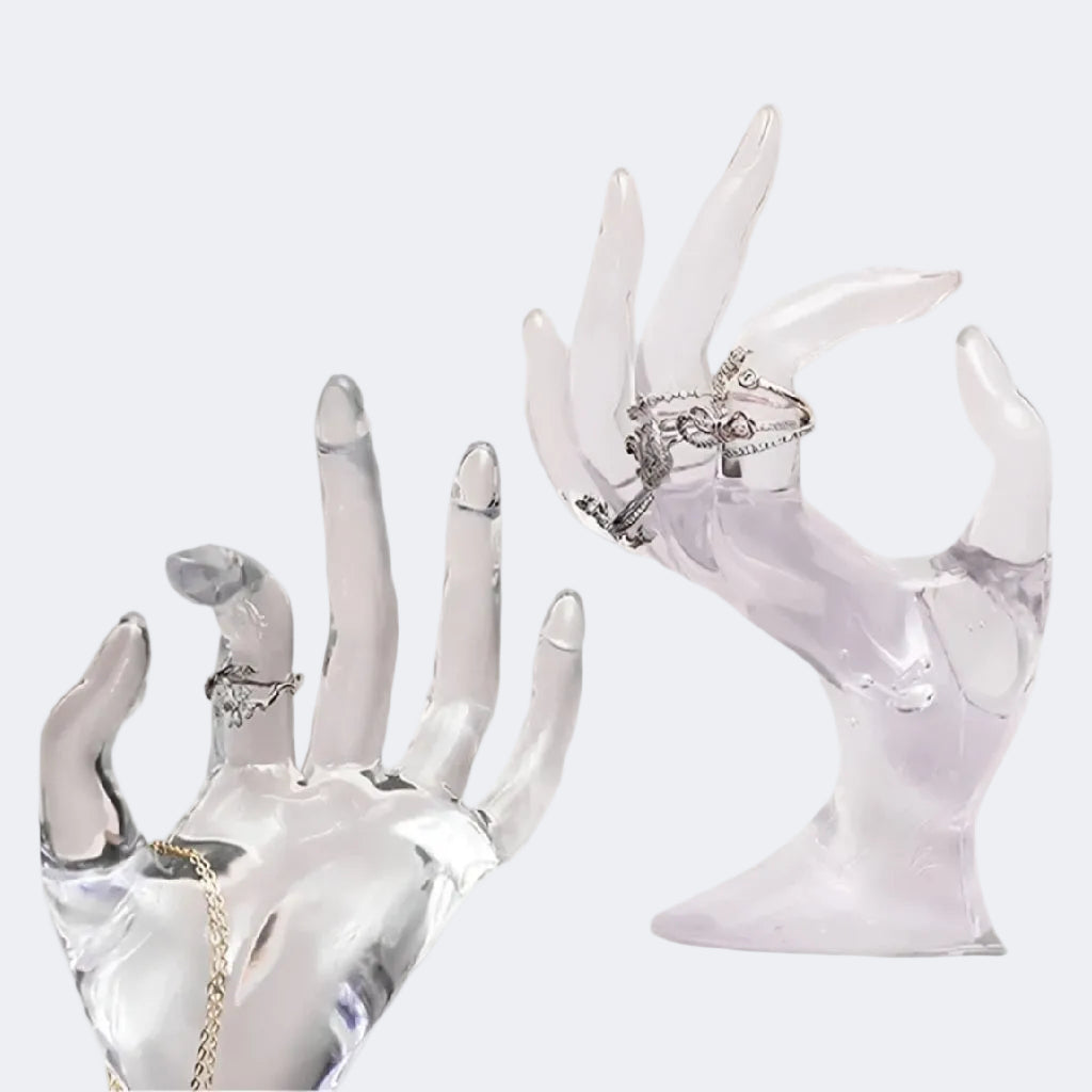 Clear acrylic hand-shaped jewelry display with rings
