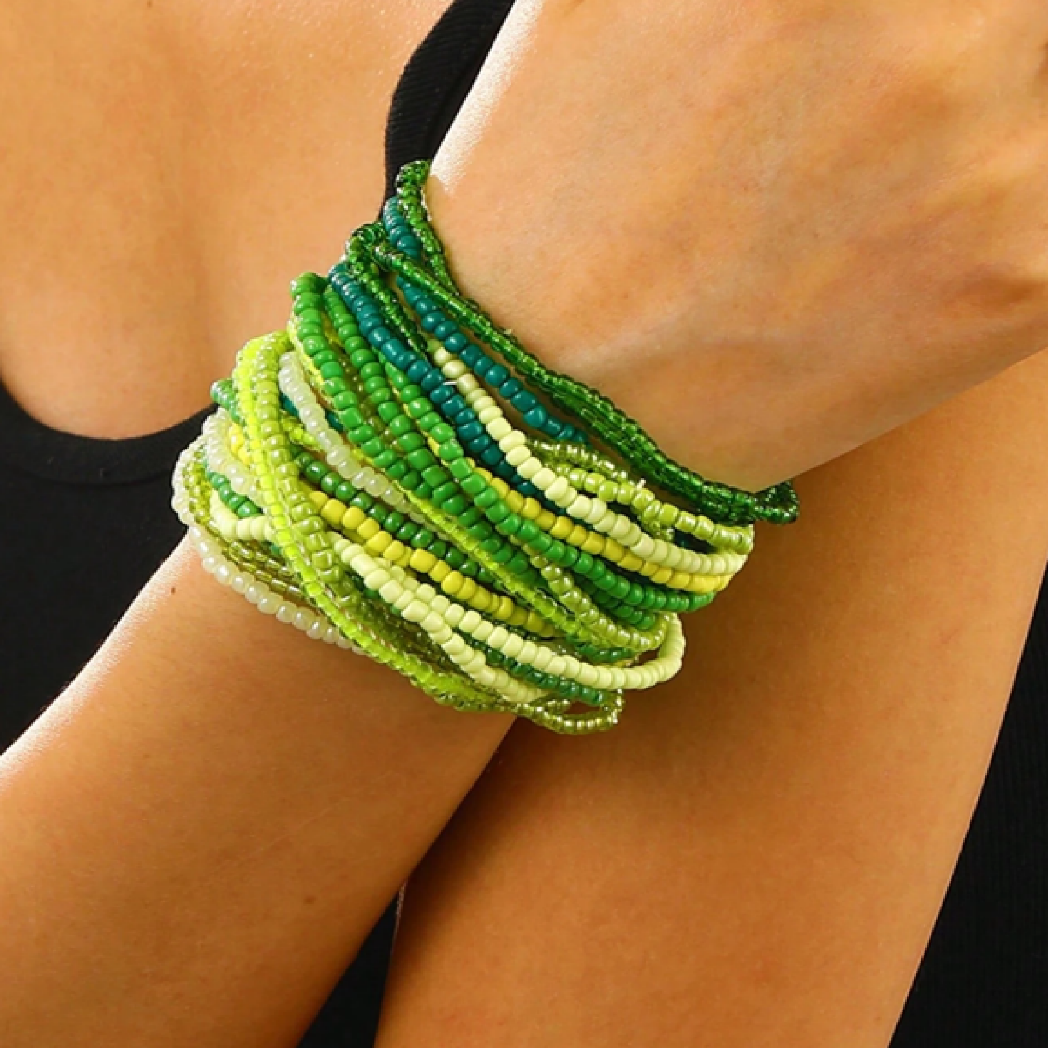 Green beaded bracelet on a wrist