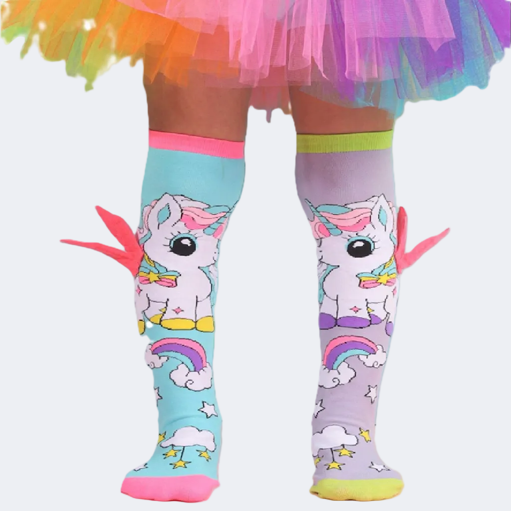 Colorful knee-high socks with unicorn design worn with a rainbow skirt.