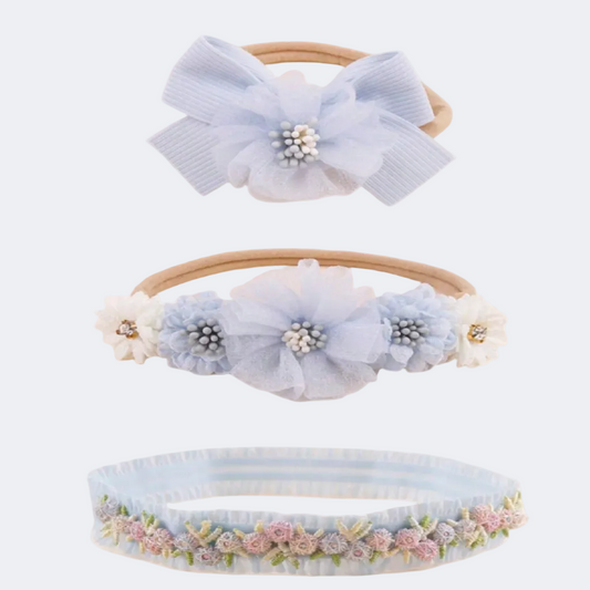 Three decorative headbands with floral and bow designs