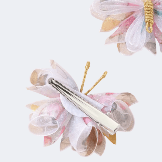 Butterfly-shaped makeup brush with floral design on a light background