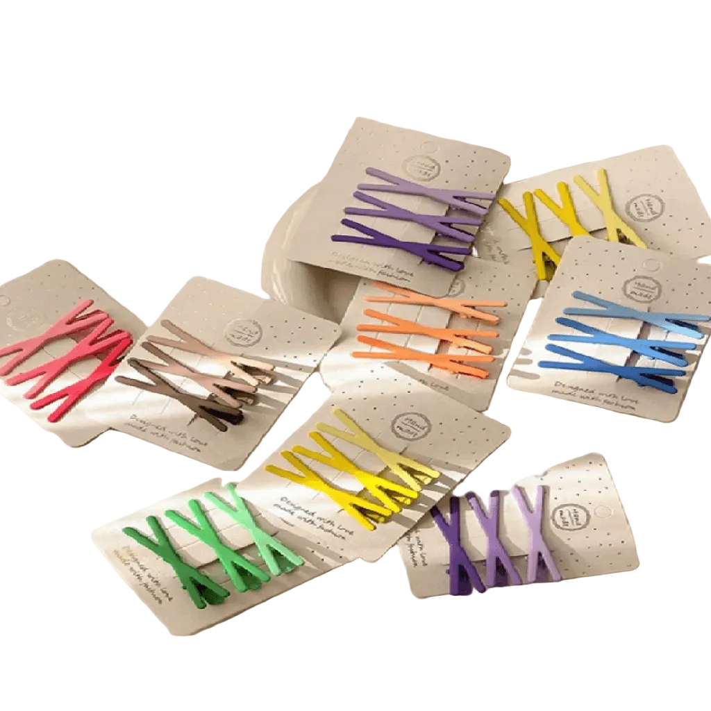 Set of colorful hair clips in packaging on a white background