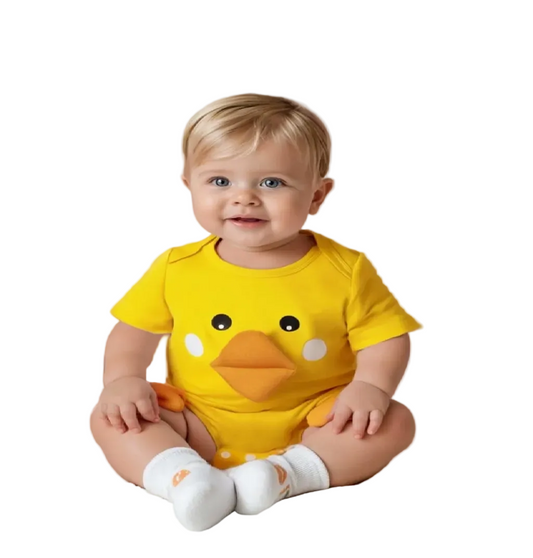 Baby wearing a yellow duck onesie in a decorated room with balloons and toys.
