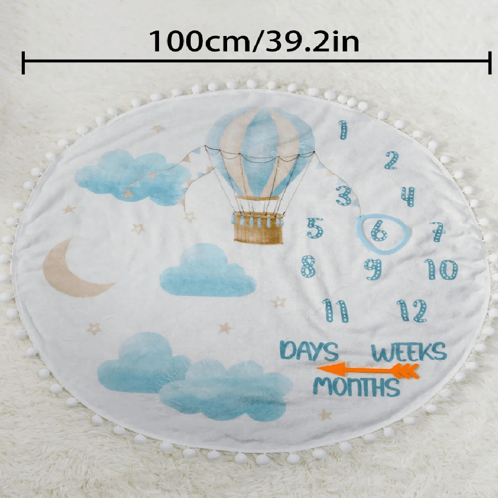 Baby milestone mat with hot air balloon design and measurement text on a white background