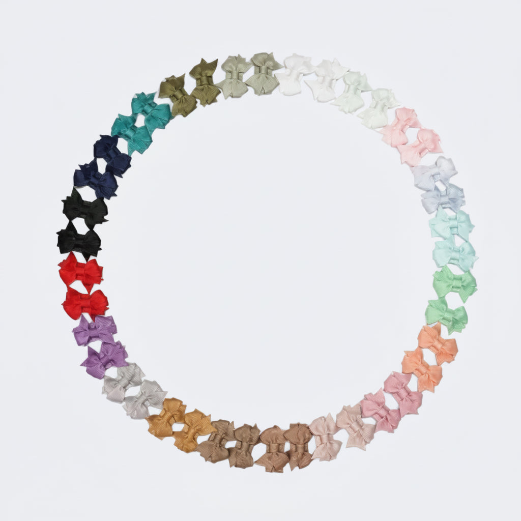Color swatch of various butterfly-shaped hair clips in a circular arrangement on a white background.
