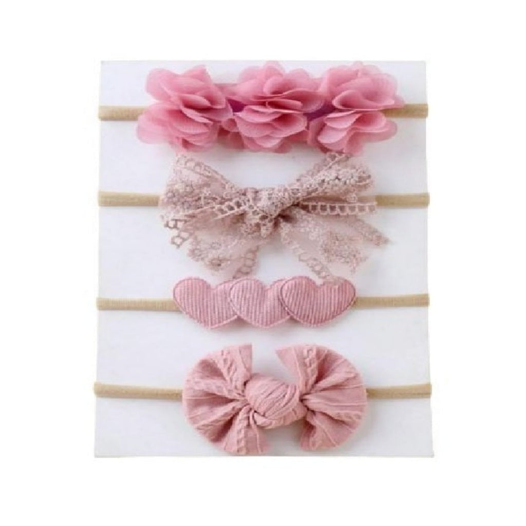Set of pink hair accessories including a headband, bow, and heart-shaped clips