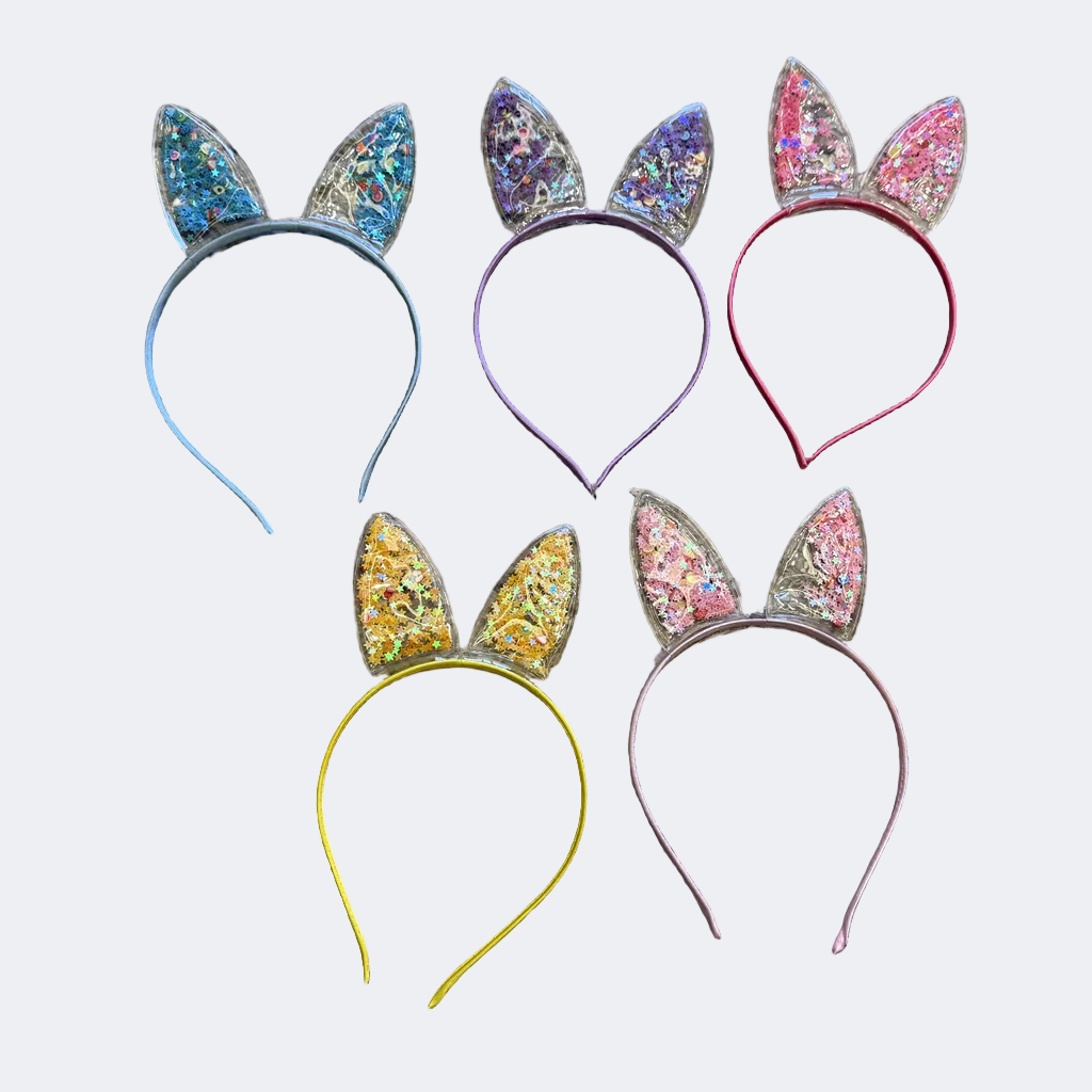 Colorful rabbit ear headbands on a textured surface