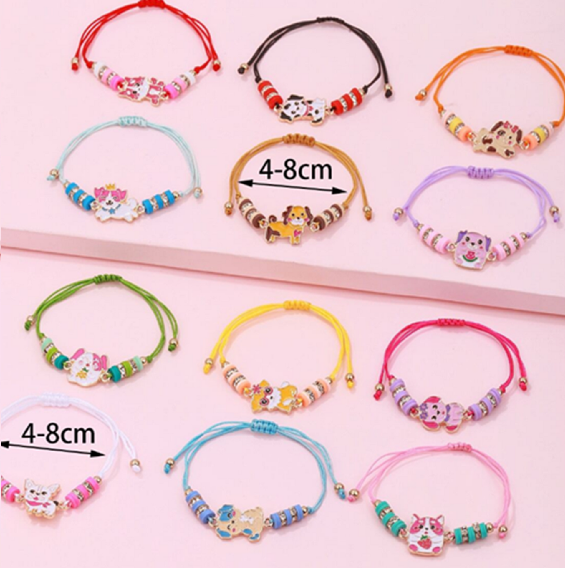 Colorful bracelets with cat charms on a pink background