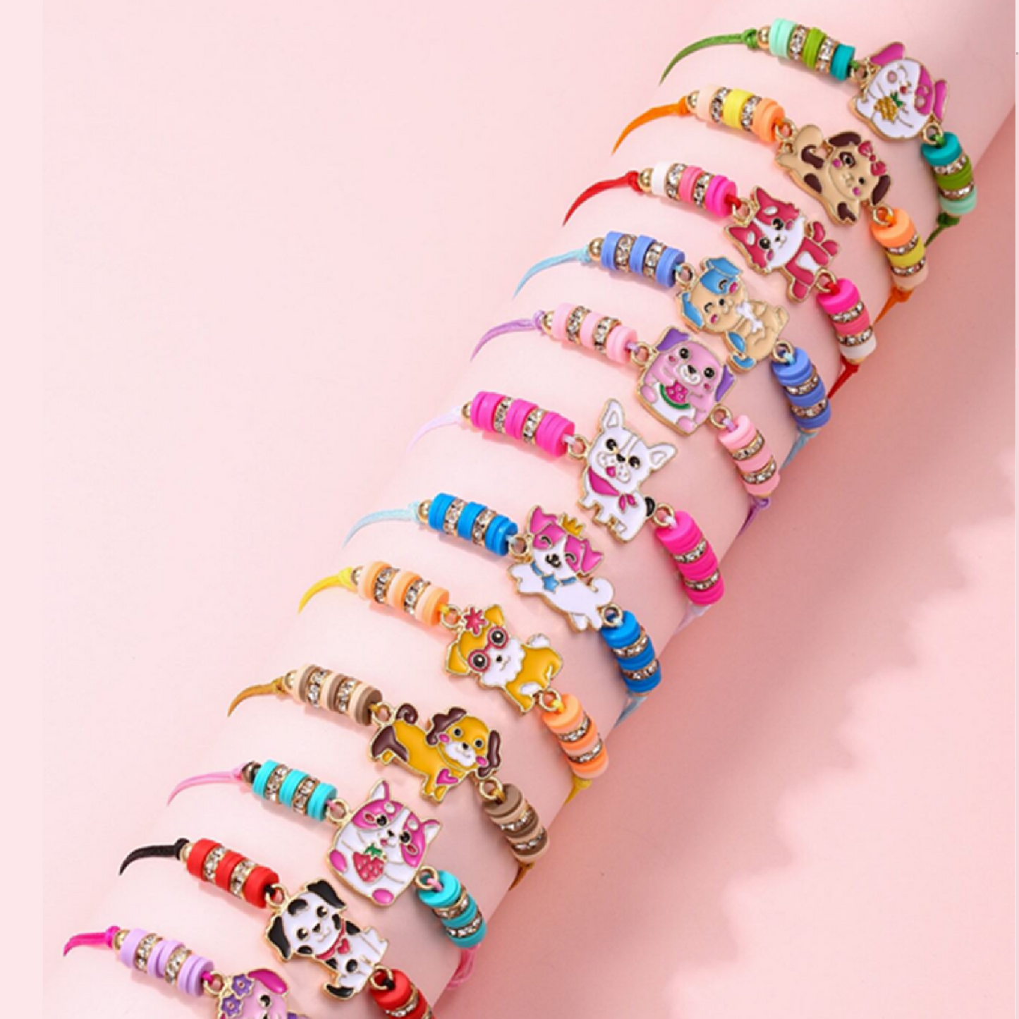 A collection of colorful braided bracelets with cat and dog charms, displayed on a cylindrical object.