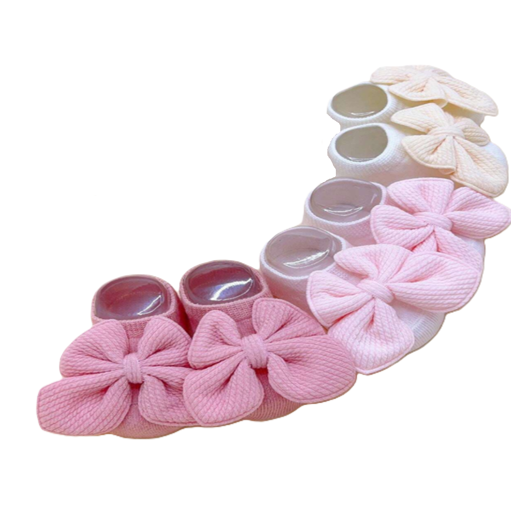 Set of pink baby booties with flower designs