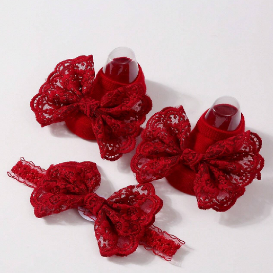 Red lace bow hair clips on a white background
