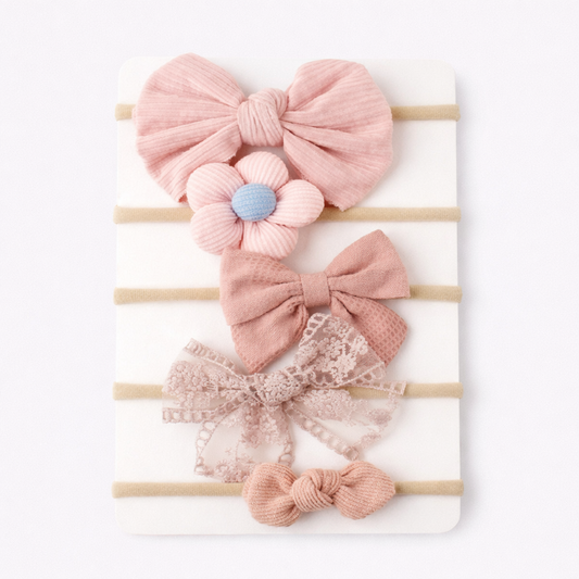 Set of pink hair bows with flowers on a white background