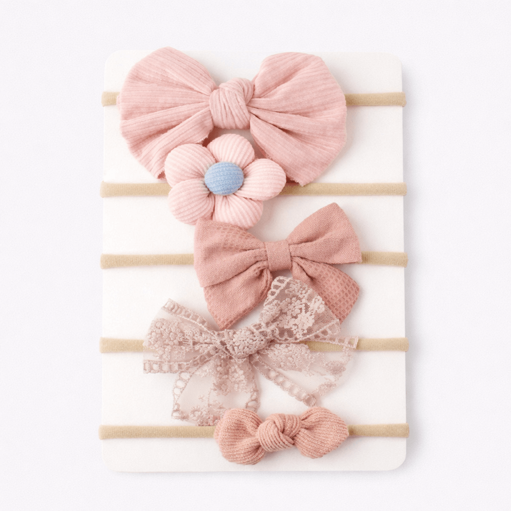 Set of pink hair bows with floral and lace details on a white background