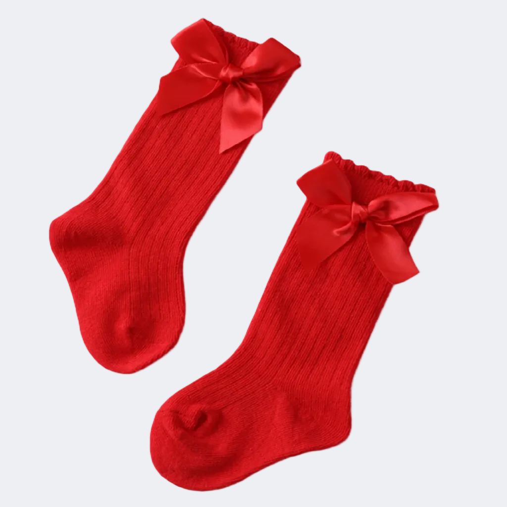 Red socks with large bows on a white background