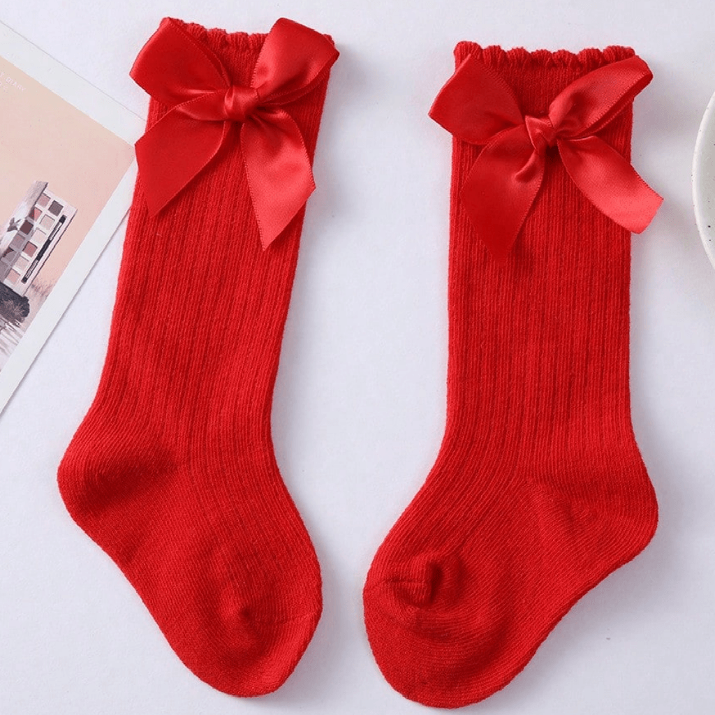 Red sock with a large bow on a white background