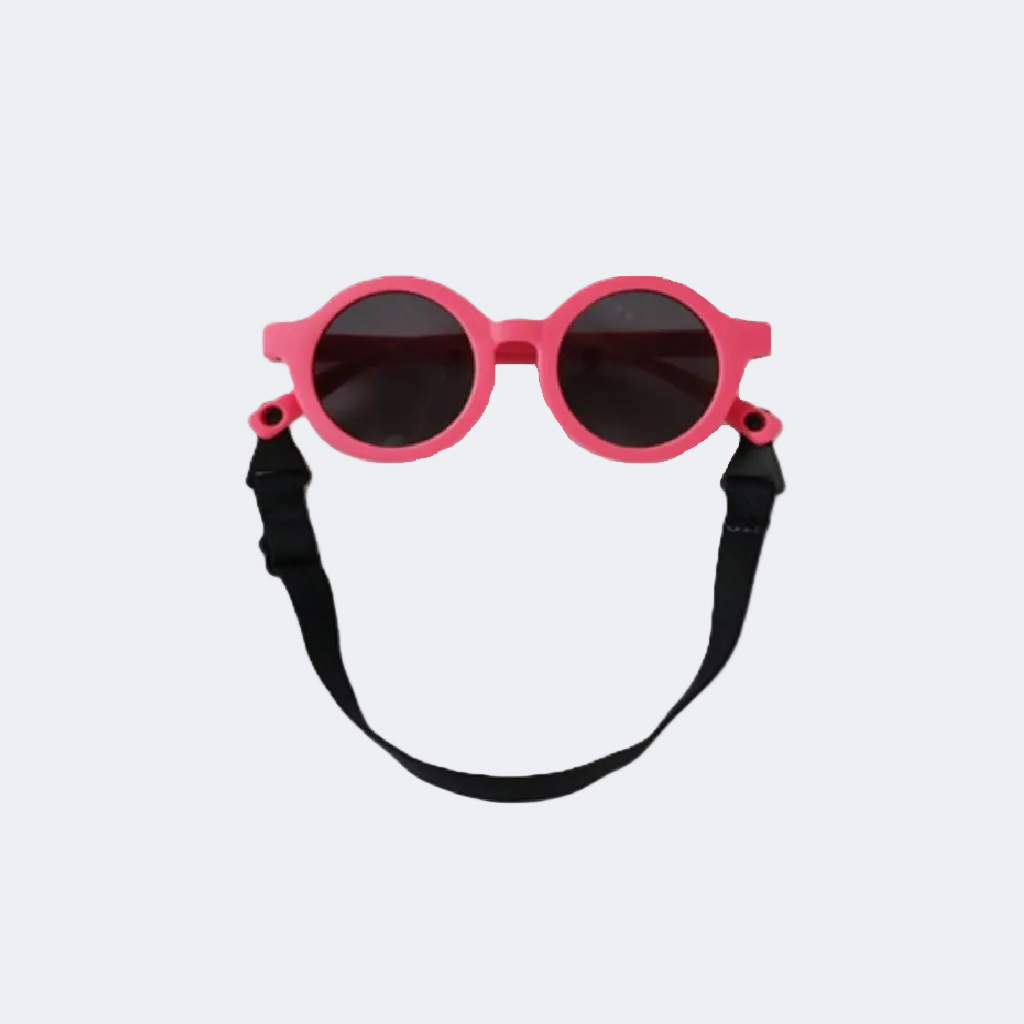 Pink sunglasses with a black strap on a light gray background