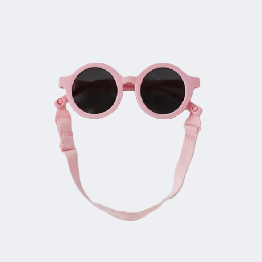 Pink sunglasses with a strap on a light gray background