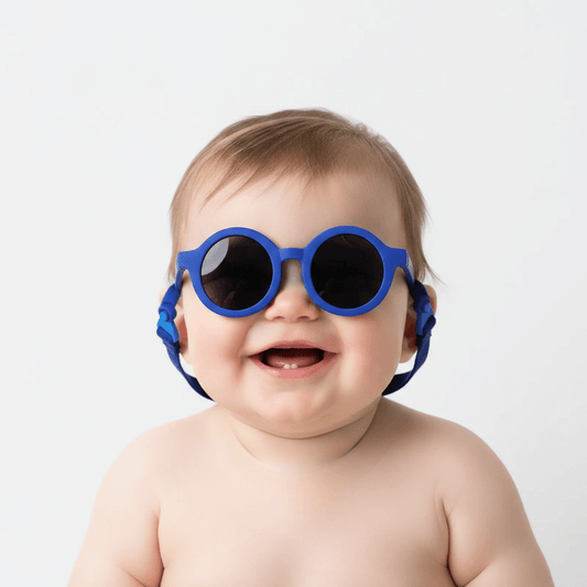 Baby wearing blue sunglasses on a white background