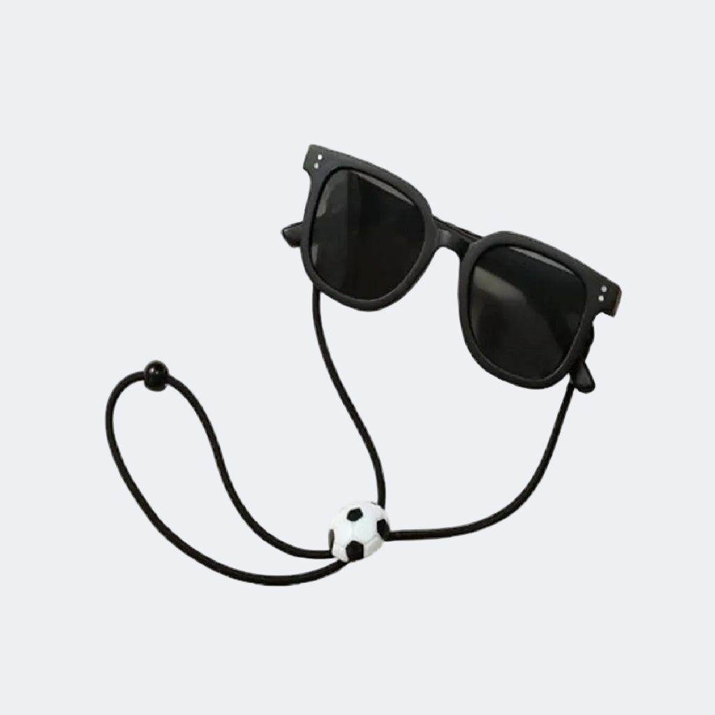 Black sunglasses with a unique strap on a light gray background