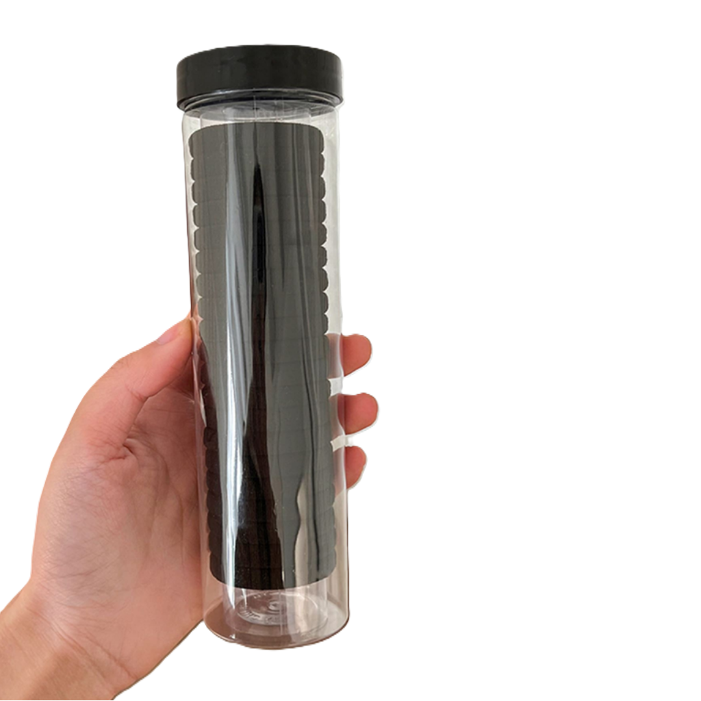 Clear tumbler with black lid held by a hand on a white background