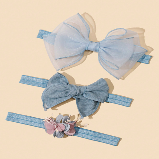 Two blue hair bows with a headband featuring floral details