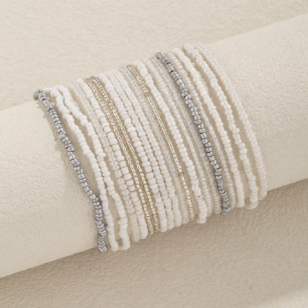 Set of beaded bracelets on a beige surface