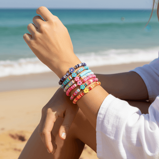 Colorful beaded bracelets on a person's wrist with a beach background
