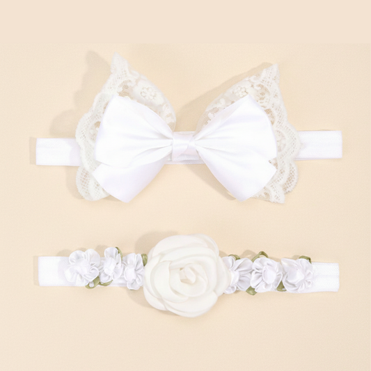 White lace headband with bow and floral headband on a beige background