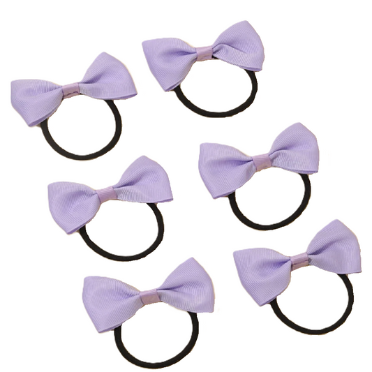 Set of five purple hair bows with black elastics on a white background