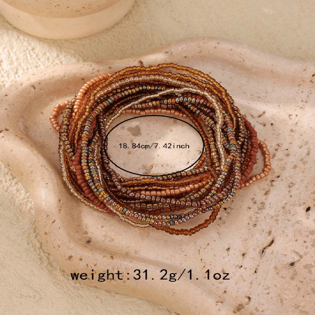 Stack of beaded bracelets on a textured stone surface